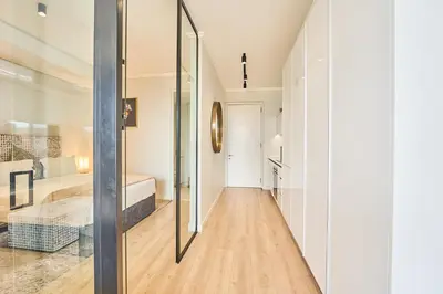 a hallway with a glass door leading to a bedroom at 8's at Ellipse Waterfall in Midrand