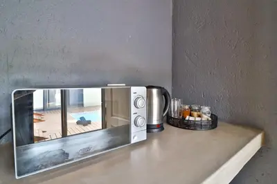 a microwave sitting on top of a counter at Ilanga Kruger Lodge in Marloth Park