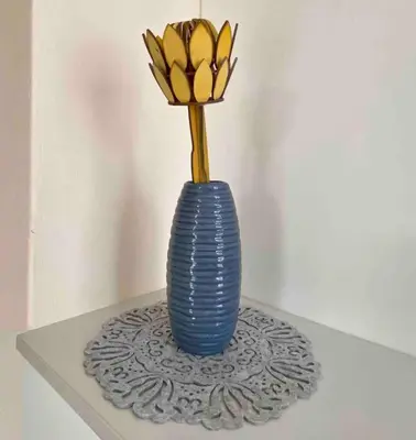 a blue vase with a flower in it on a table at Cottage on Keurboom in Midrand