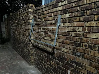 a brick wall with two metal bars on it at Serene Stays Elarduspark in Pretoria