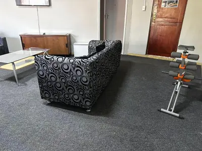 an office room with a chair and a exercise bike at Serene Stays Elarduspark in Pretoria