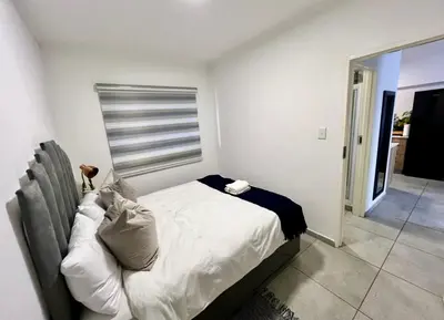 a bedroom with a bed in a room at Suburban Suites at The Reeds in Centurion