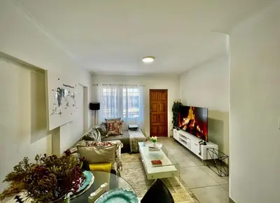 a living room with a couch and a tv at Suburban Suites at The Reeds in Centurion