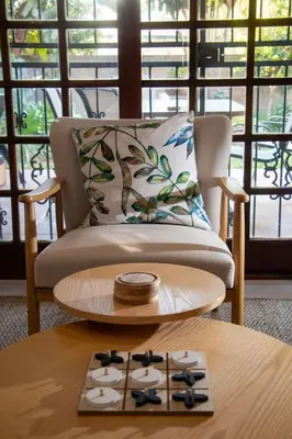 a living room with a chair and a table at Marilyn's Cottage in White River