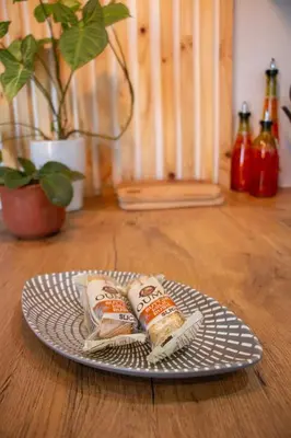 a plate with two wrapped sandwiches on a table at Marilyn's Cottage in White River