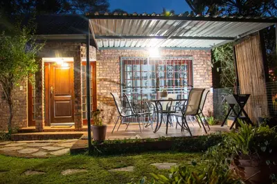 a patio with chairs and a table in a house at Marilyn's Cottage in White River