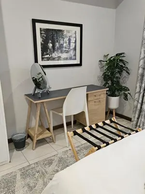 a desk with a chair and a mirror in a room at Marilyn's Cottage in White River