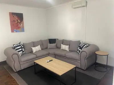 a living room with a couch and a coffee table at The Royal Kyota in Sandton