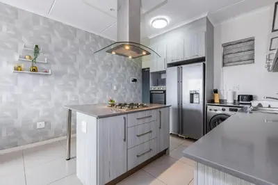 a kitchen with a stove and a counter top at Fredas Place 92 On New in Midrand