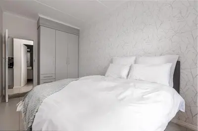 a white bed with white sheets and pillows at Fredas Place 92 On New in Midrand