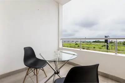 a glass table and two chairs in a room with a window at Fredas Place 92 On New in Midrand