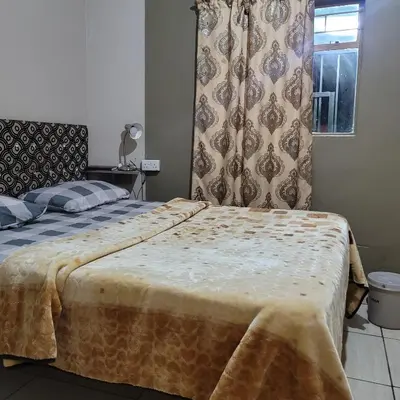 a bedroom with a large bed and a window at Delapaix Guest lodge in Kempton Park