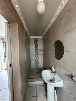 a bathroom with a sink and a shower at Riverview Pool Resort and Lodge in Moletlane