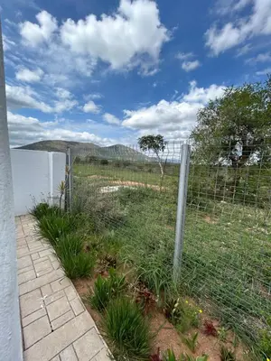 a fence in front of a body of water at Riverview Pool Resort and Lodge in Moletlane
