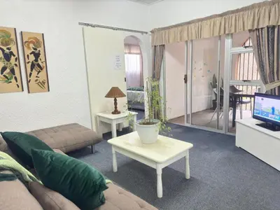 a living room with a couch and a tv at Busa House One bedroom Unit in White River