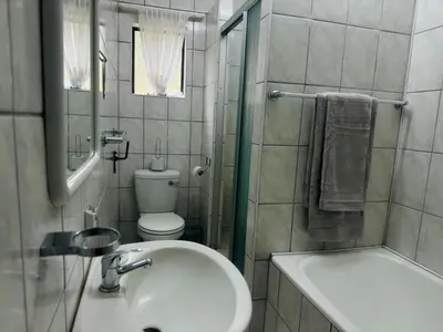 a bathroom with a sink and a toilet and a shower at Busa House One bedroom Unit in White River