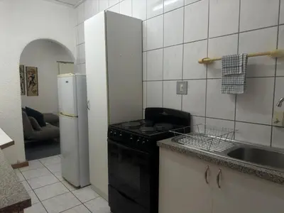 a kitchen with a stove and a sink and a refrigerator at Busa House One bedroom Unit in White River