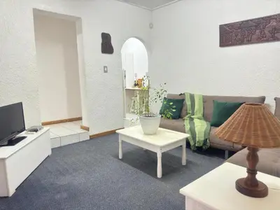 a living room with a couch and a table at Busa House One bedroom Unit in White River