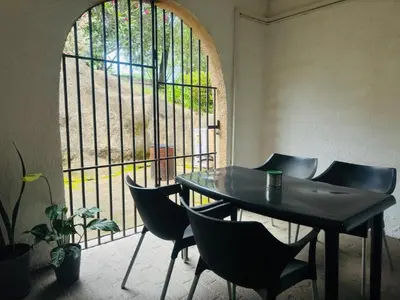 a table and chairs in a room with a window at Busa House One bedroom Unit in White River