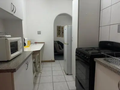 a kitchen with a stove and a refrigerator at Busa House One bedroom Unit in White River