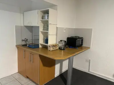 a kitchen with a counter with a microwave on it at Busa House Self-Catering Unit in White River
