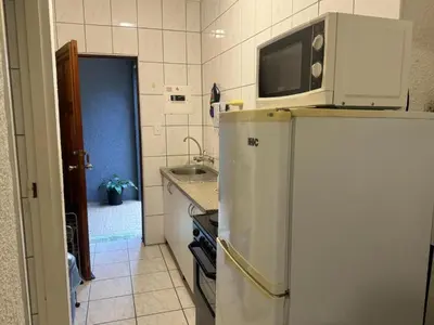 a kitchen with a microwave on top of a refrigerator at Busa House - Triple Room in White River