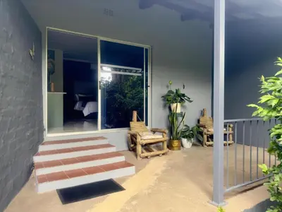 a porch with stairs and chairs on a house at Busa House Self-Catering guest house Caravan Park in White River