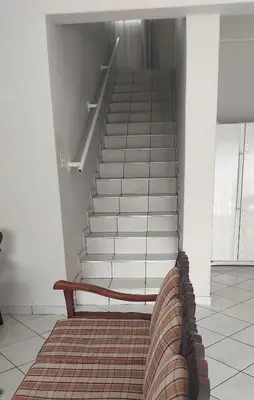 a couch sitting in front of a stair case at Brits Contractors Accommodation in Brits