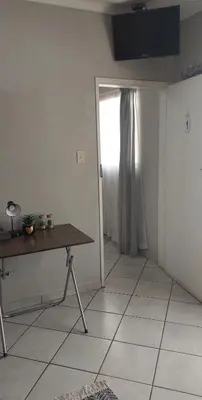 a room with a table and a door with a window at Brits Contractors Accommodation in Brits