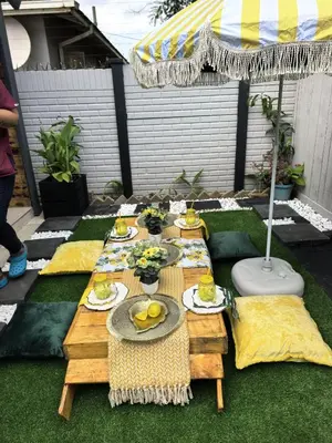 a table with plates of food on top of grass at Plein On Suid Guesthouse in Polokwane