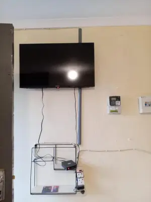 a flat screen tv hanging on a wall at Zone 4 Motel and spa in Polokwane