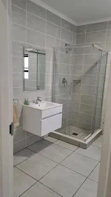 a bathroom with a shower and a sink at Apartment in Kikuyu, Waterfall in Midrand