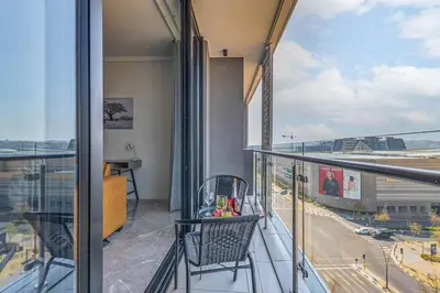 an apartment balcony with a view of an airport at Oku Luxury apartment, Ellipse, Waterfall in Midrand