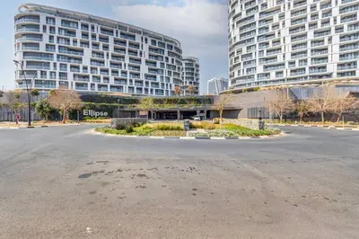 an empty parking lot in front of a large building at Oku Luxury apartment, Ellipse, Waterfall in Midrand