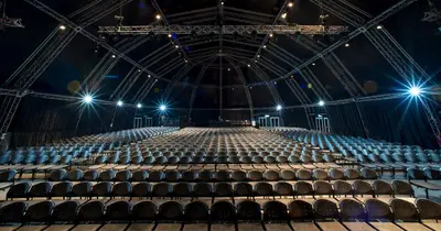 an empty arena with a stage and lights at The Ridge Hotel in Witbank