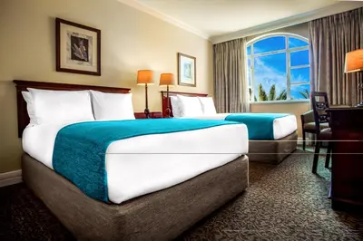 a hotel room with two beds and a window at The Ridge Hotel in Witbank