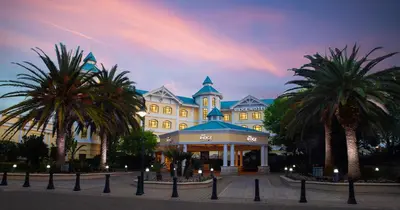 a large building with palm trees in front of it at The Ridge Hotel in Witbank
