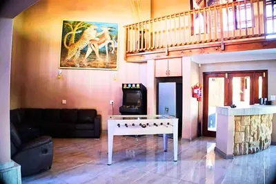 a living room with a couch and a table at Zebula Bush Lodge 47 in Moheme