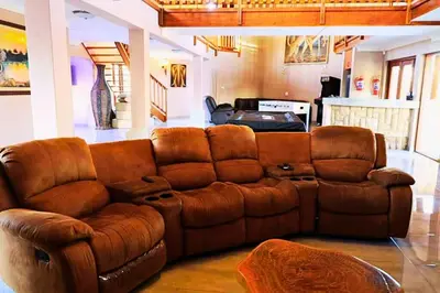 a brown leather couch in a living room at Zebula Bush Lodge 47 in Moheme