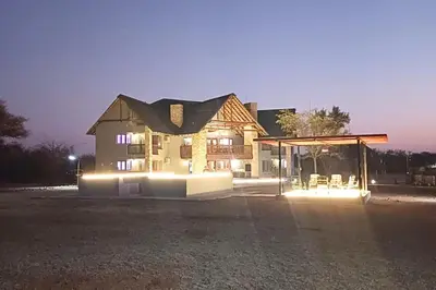 a house with lights in front of it at night at Zebula Bush Lodge 47 in Moheme