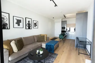 a living room with a couch and a table at City Nest - Heart of Waterfall in Midrand