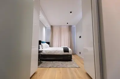 a bedroom with a bed and a window at City Nest - Heart of Waterfall in Midrand