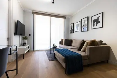 a living room with a couch and a tv at City Nest - Heart of Waterfall in Midrand