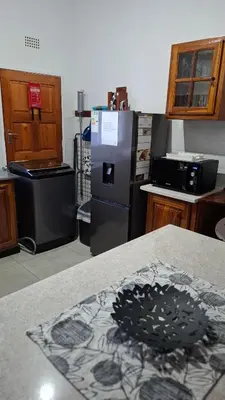 a kitchen with a stove and a refrigerator at The Big Tree selfcatering accommodation in White River