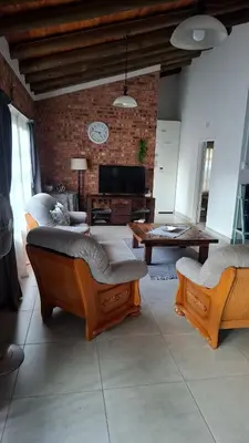 a living room with two beds and a table at The Big Tree selfcatering accommodation in White River