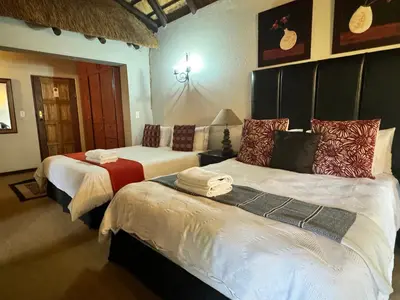 a bedroom with two beds with towels on them at Khaya Africa Guesthouse in Midrand