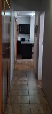 a hallway leading to a kitchen with a kitchenasteryasteryasteryasteryasteryasteryastery at Sandgrouse Guesthouse in Centurion