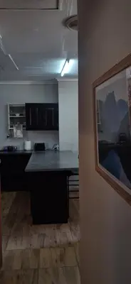 a kitchen with a counter top in a room at Sandgrouse Guesthouse in Centurion