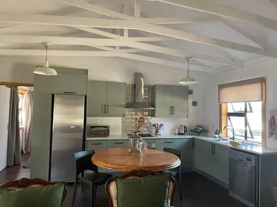 a kitchen with a table and chairs in a kitchen at Idlewood Unit 1 in Dullstroom