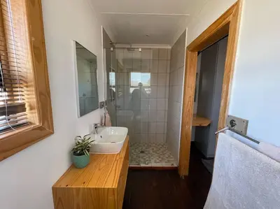 a bathroom with a sink and a shower at Idlewood Unit 1 in Dullstroom